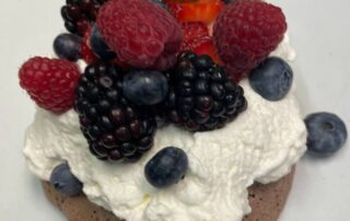 Pavlova dessert with cream and berries